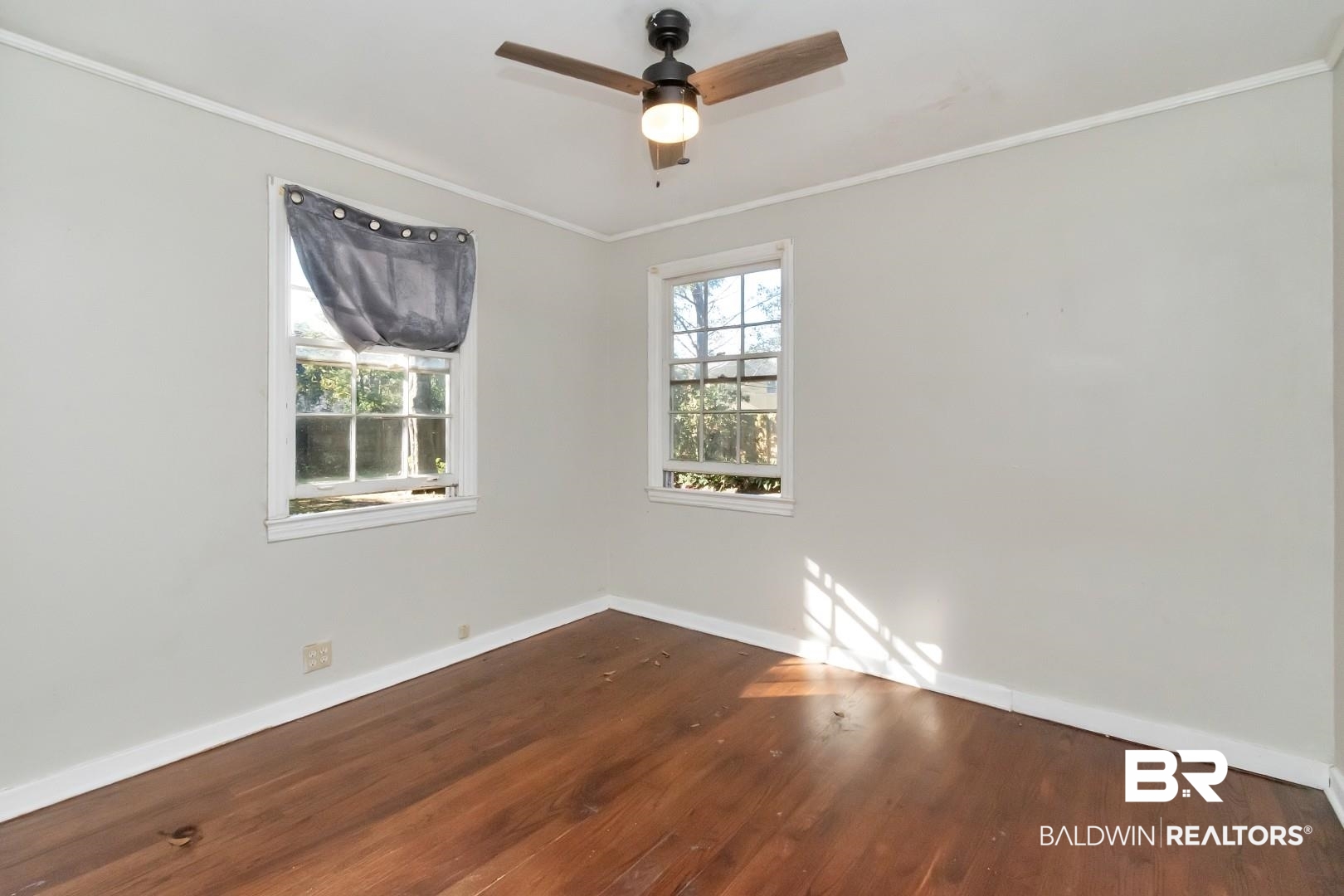 5001 Hillwood Circle South Mobile, AL 36608 - Photo 17 of 20 Unfurnished room featuring ornamental molding, wood finished floors, a ceiling fan, and baseboards