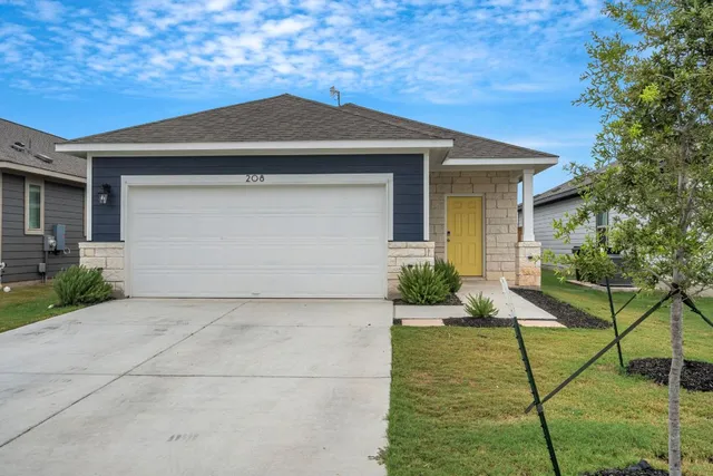 a front view of a house with a yard