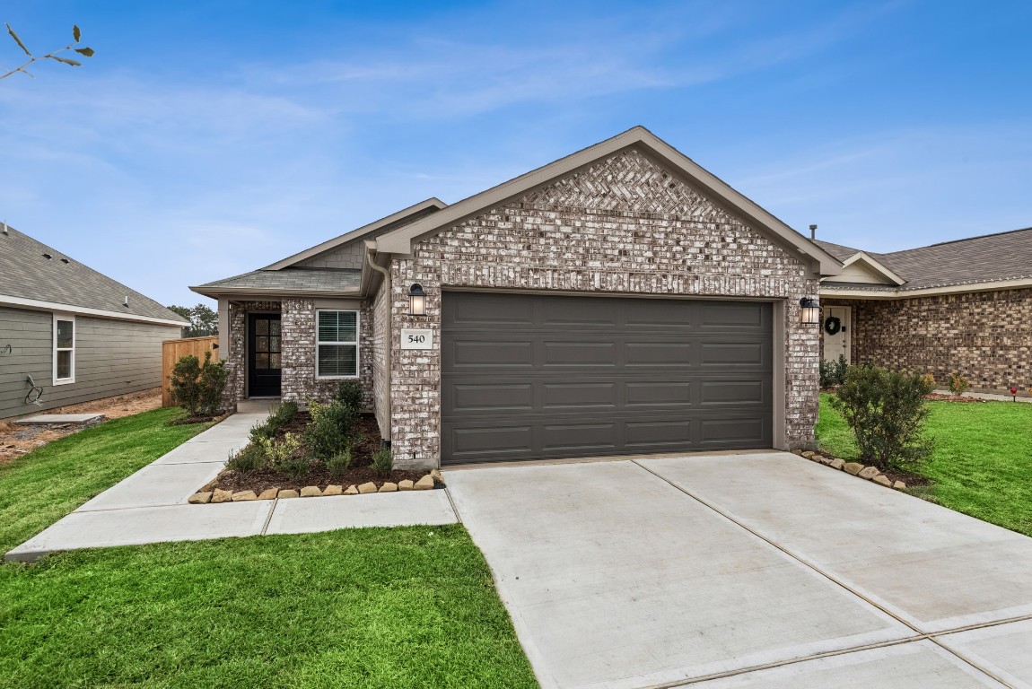 540 Flower Reed Court Magnolia, TX 77354 - Photo 12 of 45 a front view of a house with a yard and garage