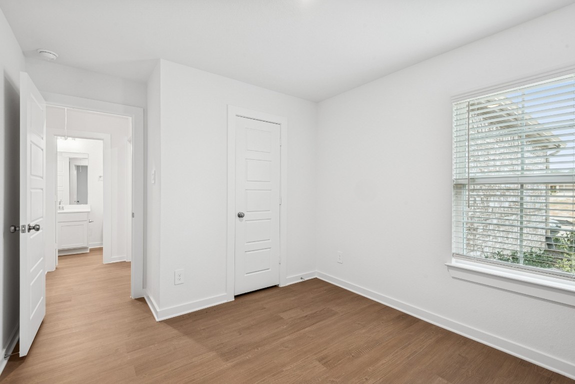 540 Flower Reed Court Magnolia, TX 77354 - Photo 15 of 45 a view of an empty room with wooden floor and a window