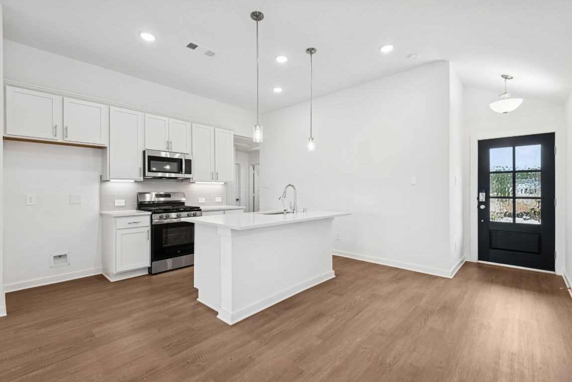 540 Flower Reed Court Magnolia, TX 77354 - Photo 17 of 45 a large kitchen with stainless steel appliances sink a microwave and cabinets