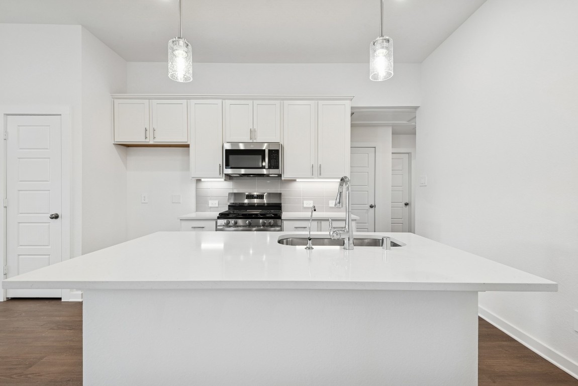 540 Flower Reed Court Magnolia, TX 77354 - Photo 2 of 45 a kitchen with kitchen island a sink appliances and cabinets