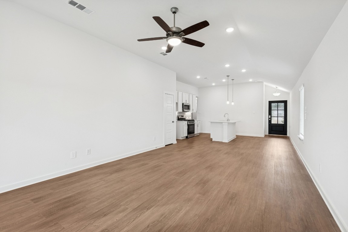 540 Flower Reed Court Magnolia, TX 77354 - Photo 22 of 45 a view of an empty room and kitchen with wooden floor