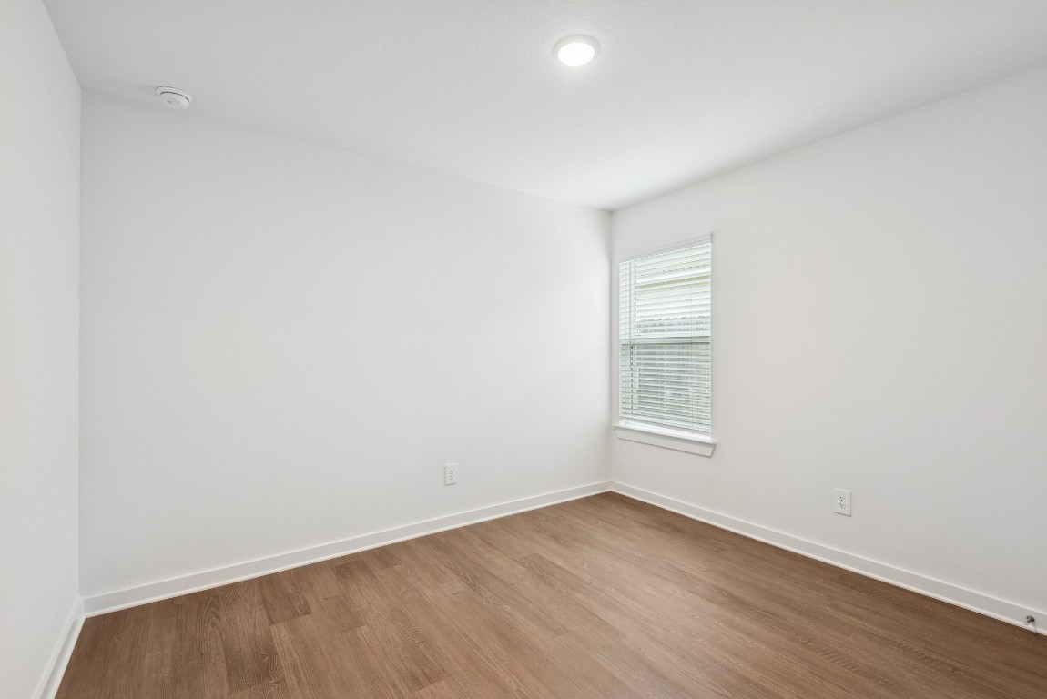 540 Flower Reed Court Magnolia, TX 77354 - Photo 27 of 45 an empty room with wooden floor and windows