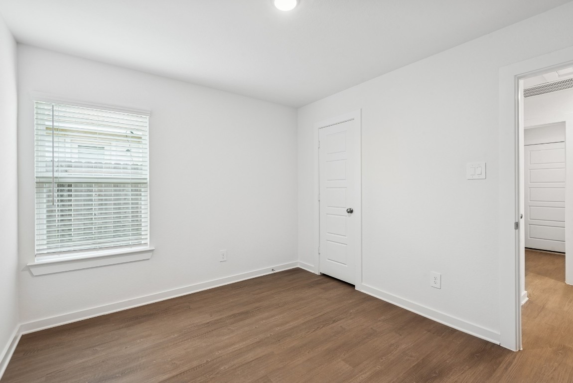 540 Flower Reed Court Magnolia, TX 77354 - Photo 29 of 45 a view of an empty room with wooden floor and a window
