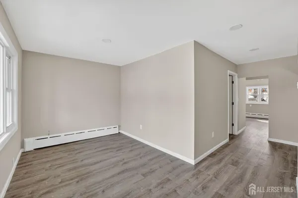 a view of a room with wooden floor