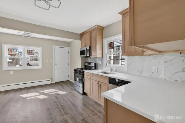 a kitchen with granite countertop a stove and a sink