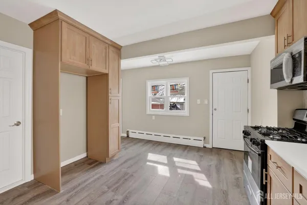 a view of a kitchen with wooden floor and a sink