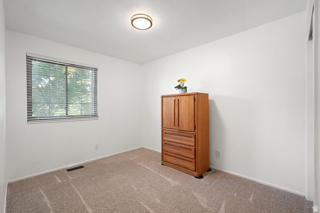 865 South 325 West Orem, UT 84058 - Photo 19 of 38 Carpeted room with a window featuring blinds, a white ceiling, and a flush-mount light fixture