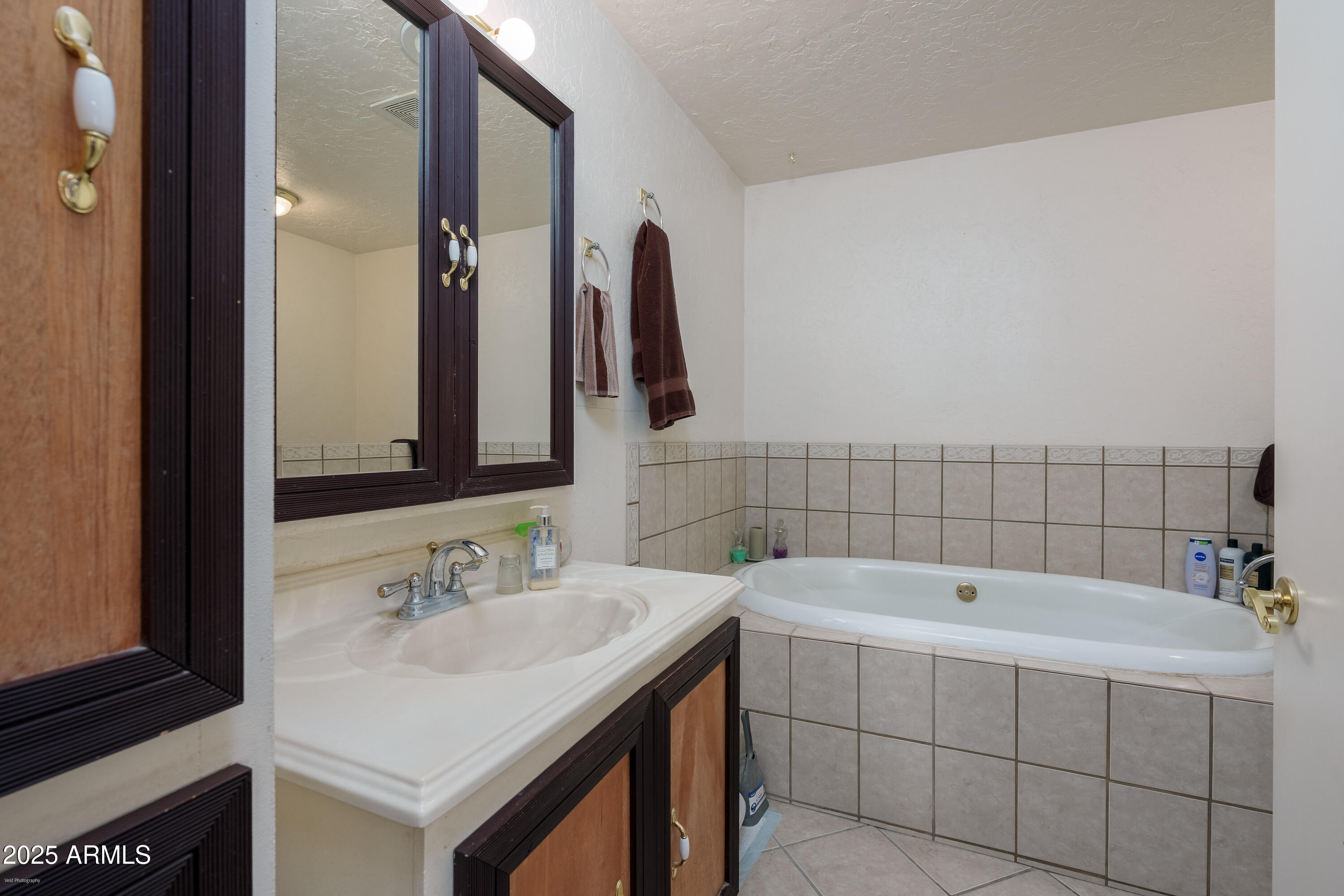 3510 East Maybe Manana Way Rimrock, AZ 86335 - Photo 14 of 36 a bathroom with a sink and a bathtub