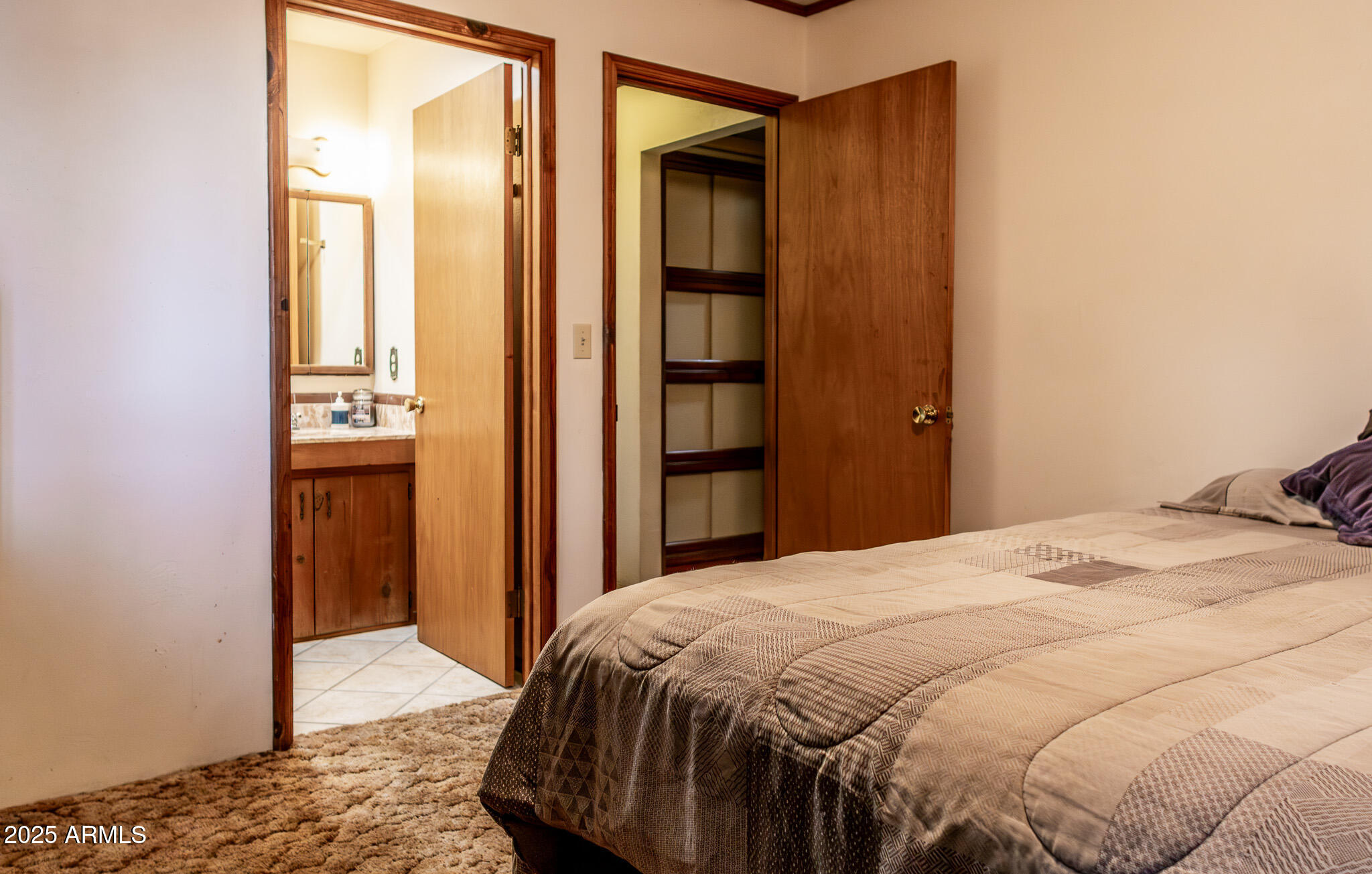 3510 East Maybe Manana Way Rimrock, AZ 86335 - Photo 17 of 36 a bedroom with a bed and wooden floor