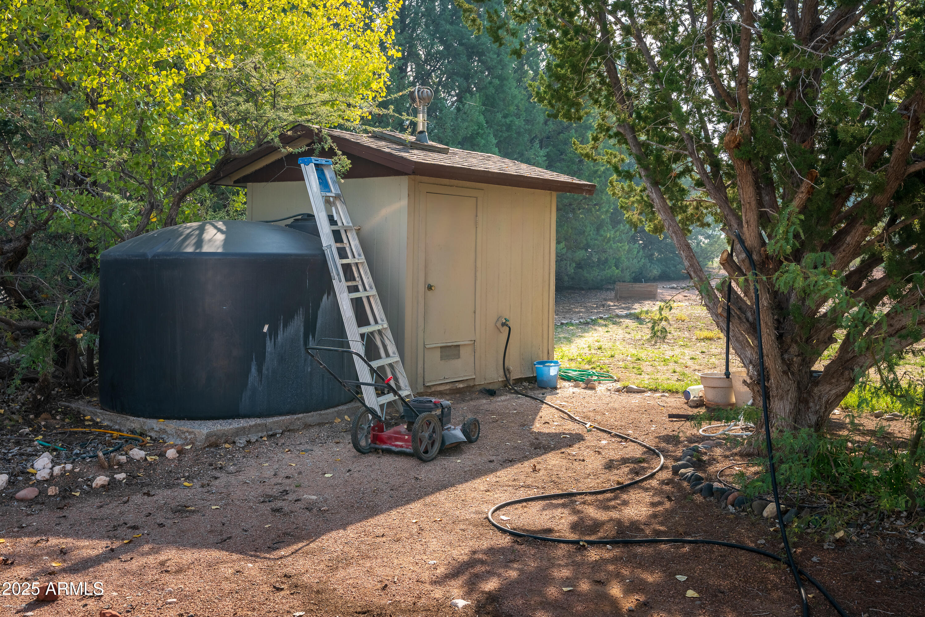 3510 East Maybe Manana Way Rimrock, AZ 86335 - Photo 36 of 36 a view of backyard with a barn and a large tree