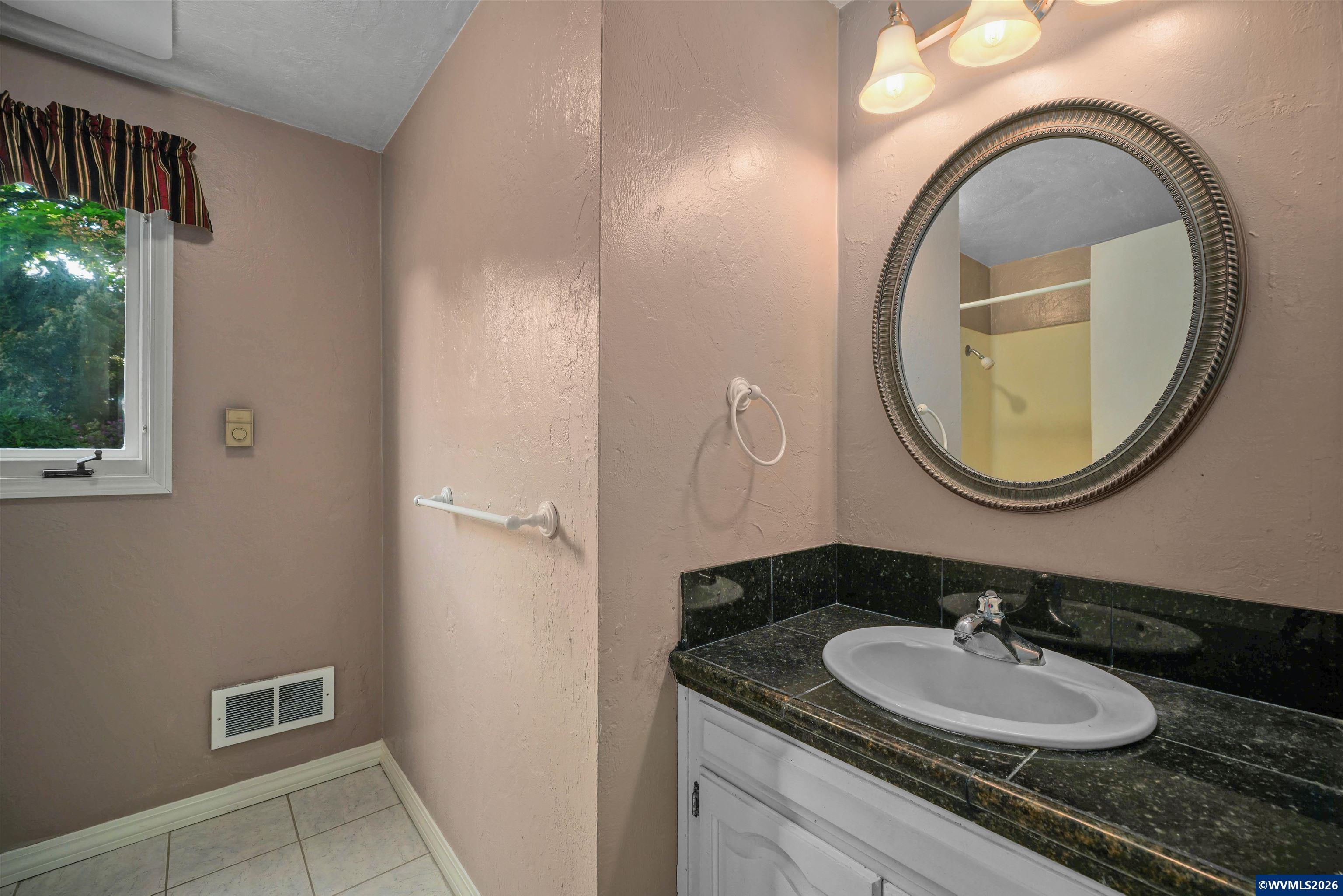 220 Northwest Downy Drive Sublimity, OR 97385 - Photo 26 of 47 a bathroom with a granite countertop sink and a mirror