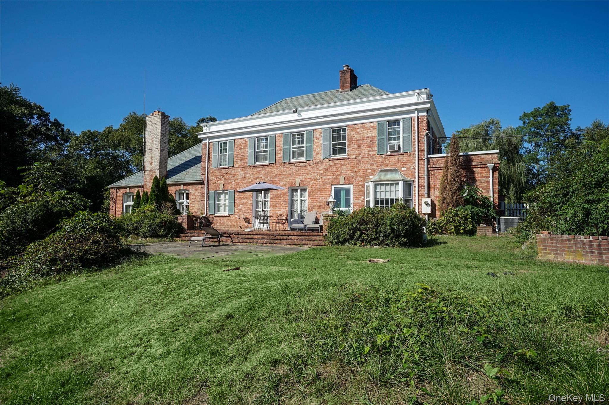 274 River Road St. James, NY 11780 - Photo 23 of 30 a front view of a house with a yard