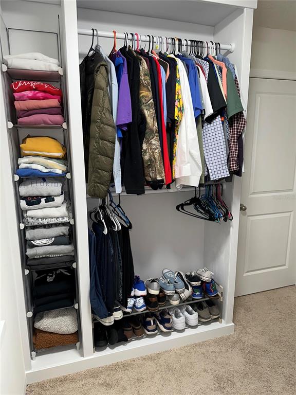 1439 Northwest 136th Street Gainesville, FL 32606 - Photo 17 of 28 a view of walk in closet with clothes and shoes