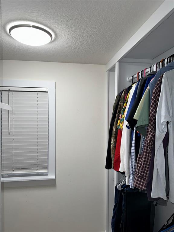 1439 Northwest 136th Street Gainesville, FL 32606 - Photo 18 of 28 a view of walk in closet with clothes and shoes