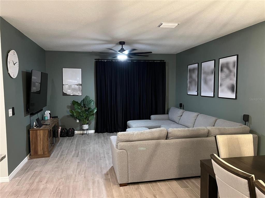 1439 Northwest 136th Street Gainesville, FL 32606 - Photo 2 of 28 a living room with furniture and a flat screen tv