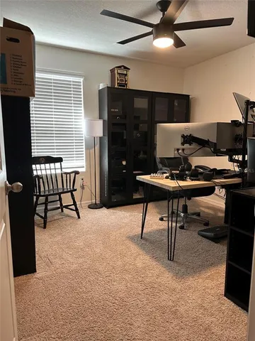 a bedroom with bed couch and window