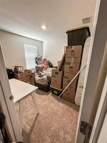 a view of a backyard with sitting area and wooden fence