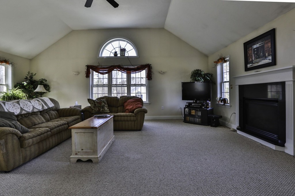 501 Oakham Road Barre, MA 01005 - Photo 4 of 25 a living room with furniture a fireplace and a flat screen tv