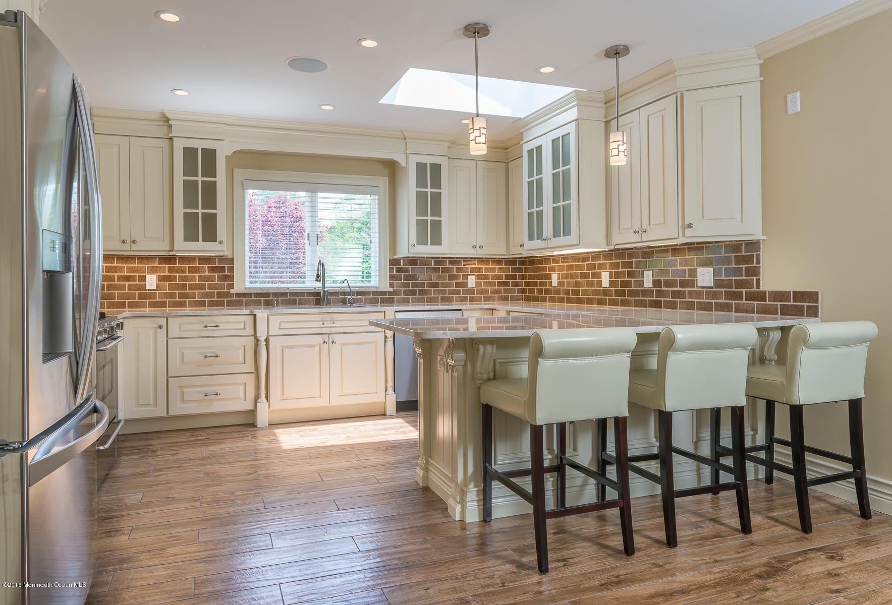 17 Heyers Mill Road Colts Neck, NJ 07722 - Photo 2 of 26 a kitchen with cabinets and chairs