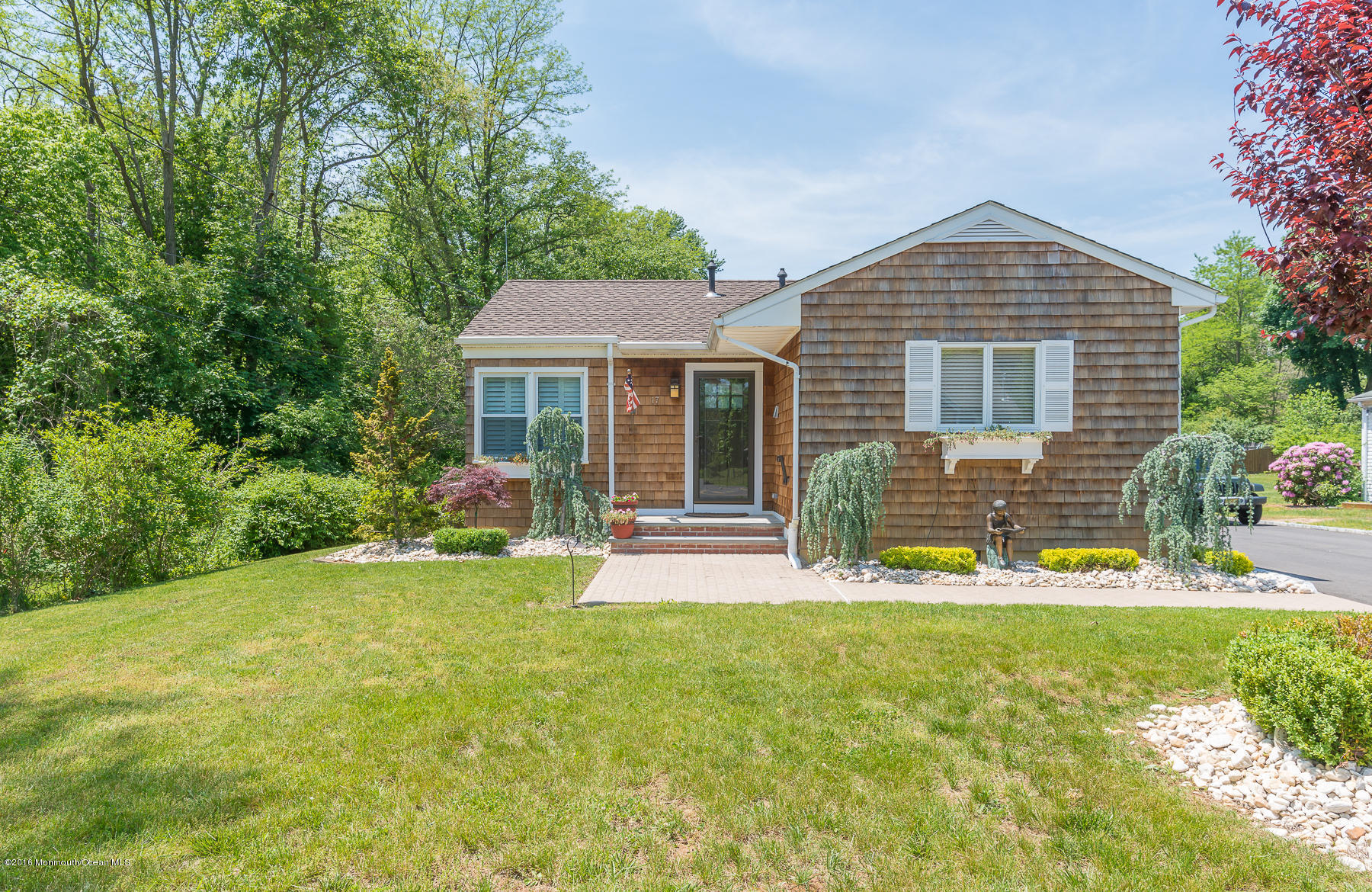 17 Heyers Mill Road Colts Neck, NJ 07722 - Photo 23 of 26 a front view of house with yard and green space