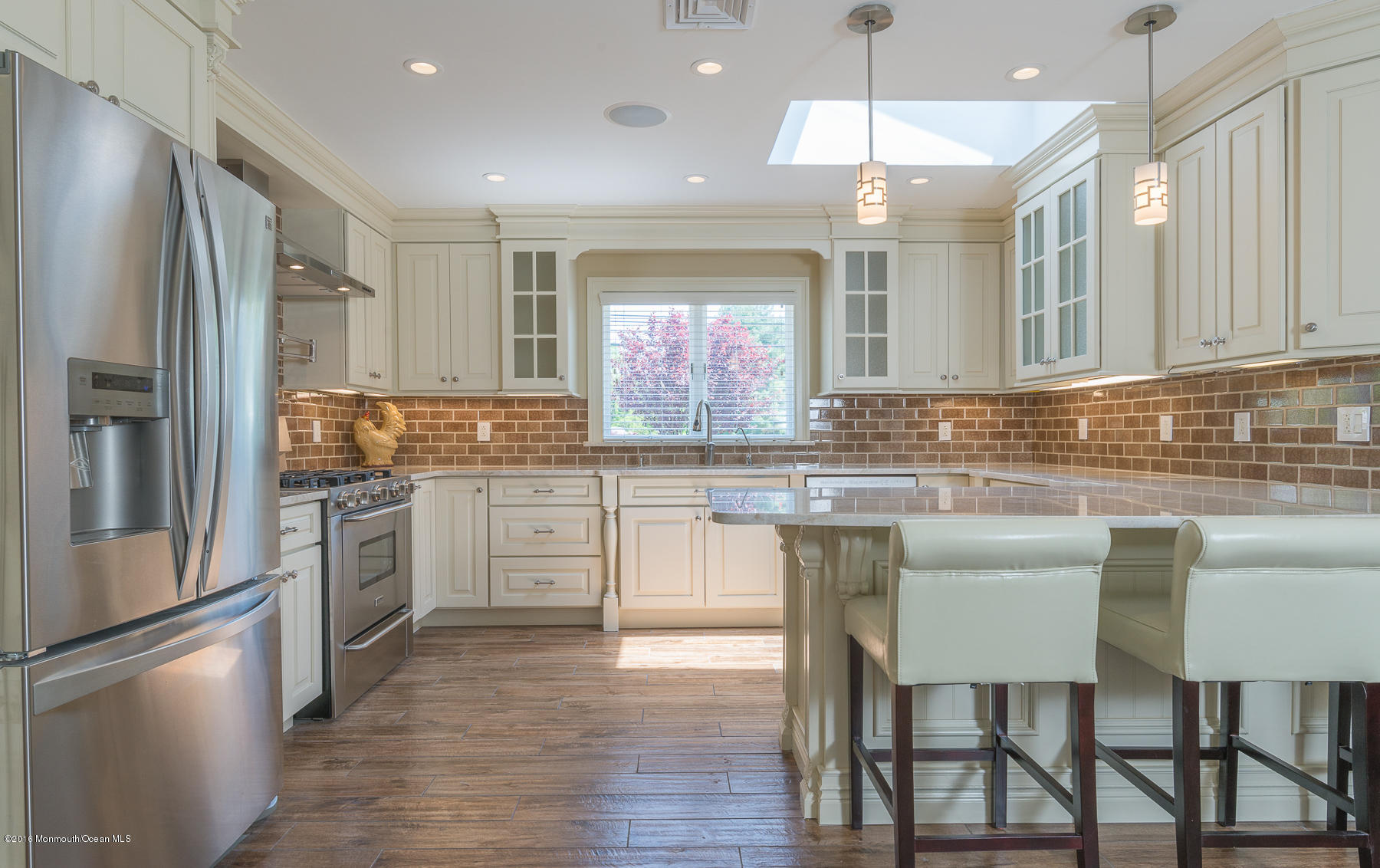 17 Heyers Mill Road Colts Neck, NJ 07722 - Photo 3 of 26 a kitchen with stainless steel appliances granite countertop a stove a sink refrigerator and a refrigerator