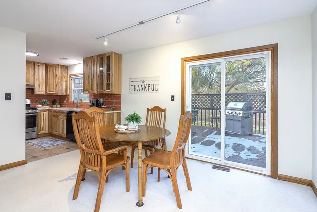 a dining room with furniture and a floor to ceiling window