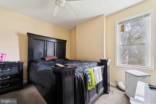 a bedroom with a bed and a window