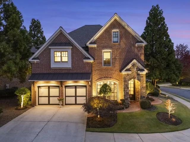 a view of a patio with couches table and chairs under an umbrella