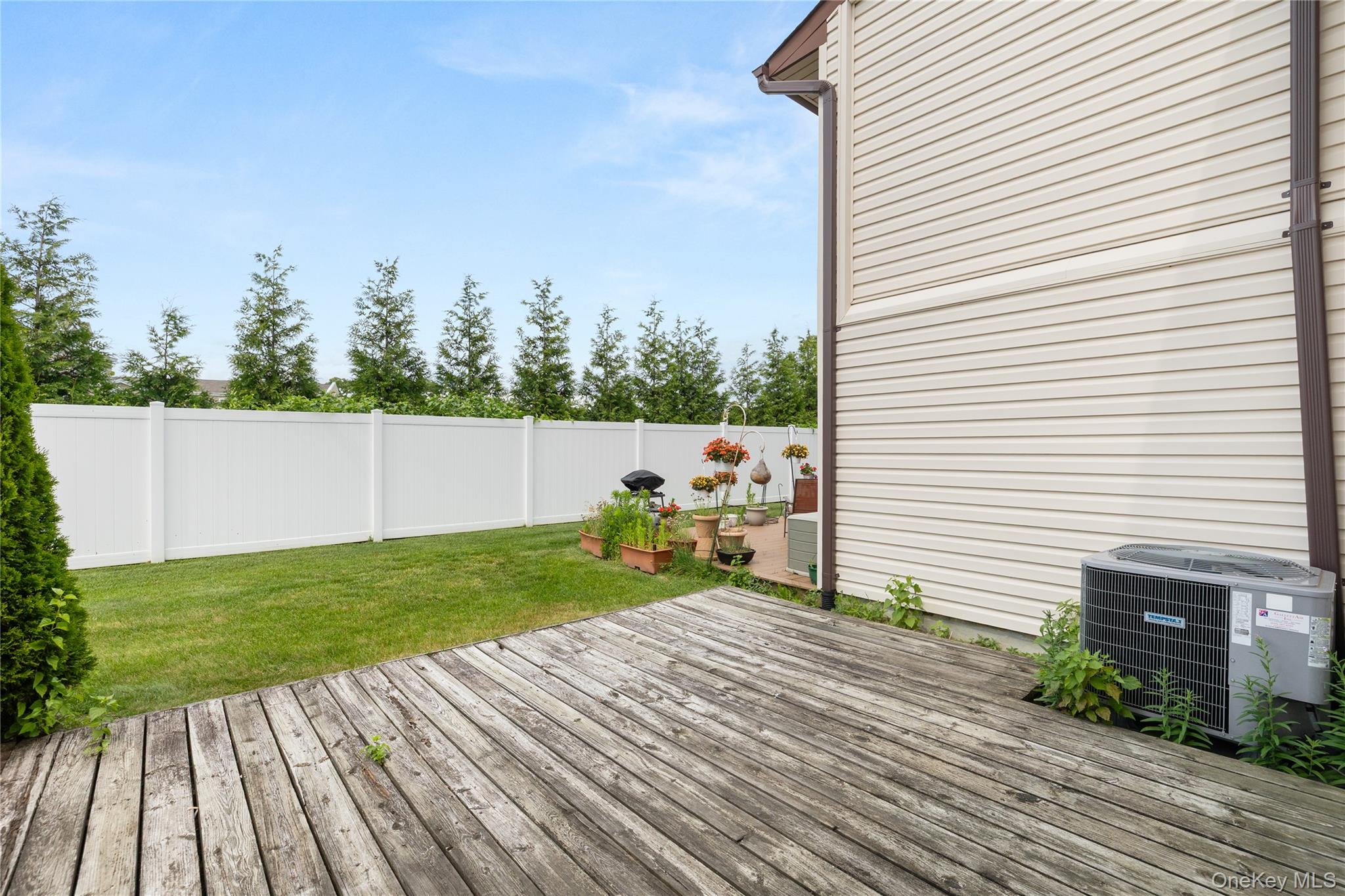 650 Newbridge Road, Unit 15 East Meadow, NY 11554 - Photo 16 of 20 a view of a backyard with sitting area