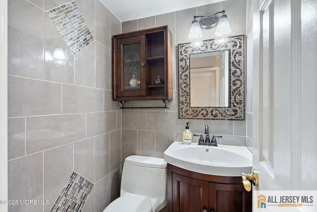 a bathroom with a sink toilet and mirror