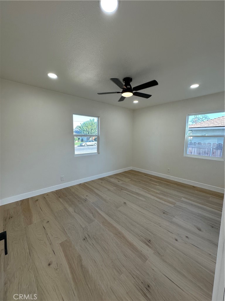 4364 Vía San Luis Riverside, CA 92504 - Photo 11 of 23 an empty room with wooden floor fan and windows