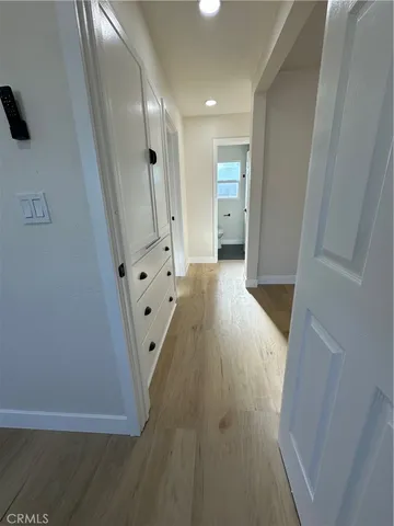a view of a hallway with wooden floor