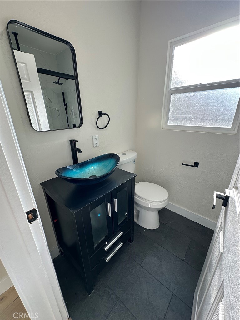 4364 Vía San Luis Riverside, CA 92504 - Photo 16 of 23 a bathroom with a toilet sink and mirror