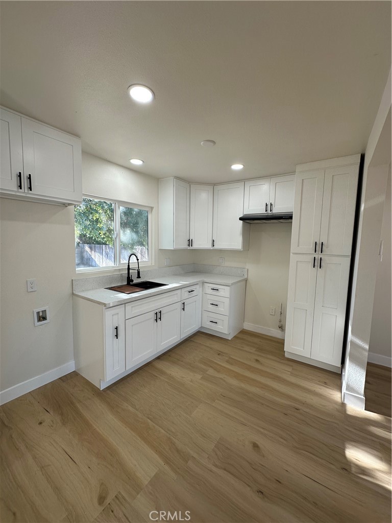 4364 Vía San Luis Riverside, CA 92504 - Photo 7 of 23 a kitchen with white cabinets and white appliances