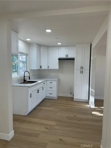 a kitchen with granite countertop a sink and cabinets