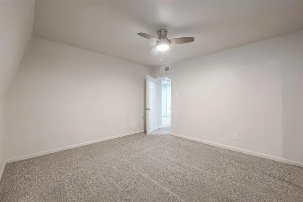 a view of an empty room with a fan