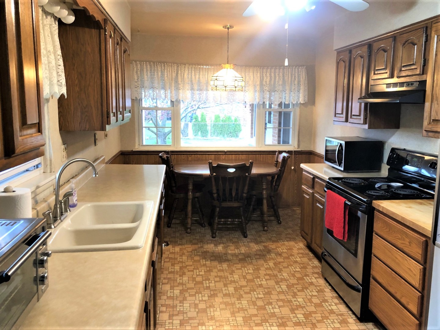 408 North Aldine Avenue Park Ridge, IL 60068 - Photo 4 of 12 a kitchen with stainless steel appliances granite countertop a sink stove and refrigerator