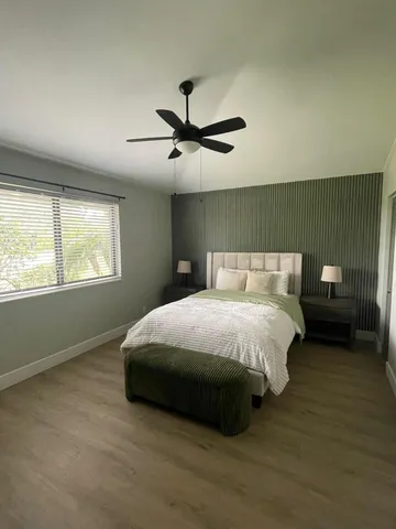 a bedroom with a bed and window