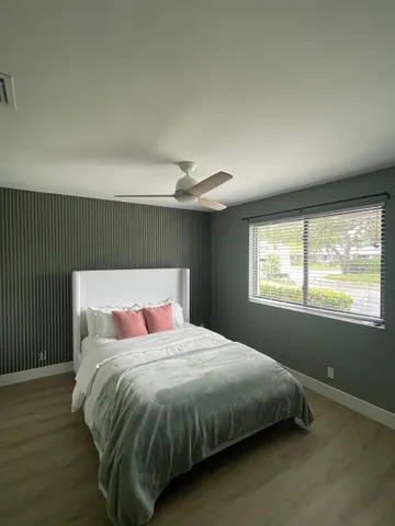 a bedroom with a large bed and a window