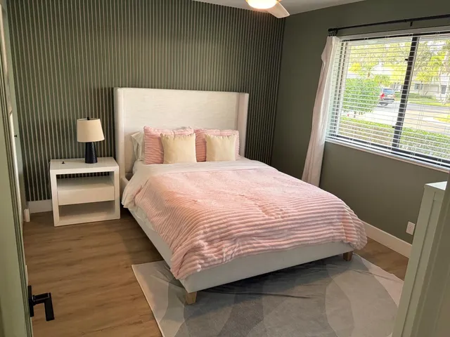 a bedroom with a bed and window