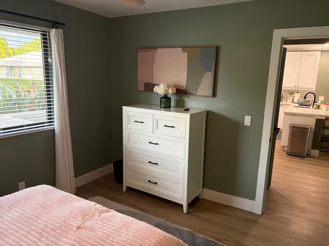 a bedroom with a bed and a dresser