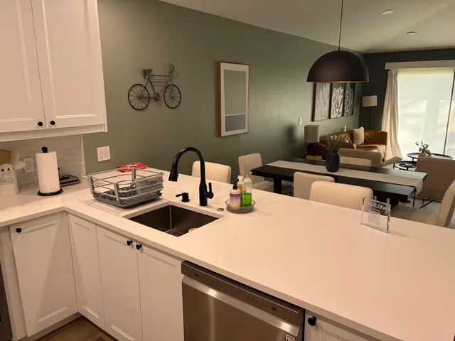 a kitchen with a sink a stove and cabinets