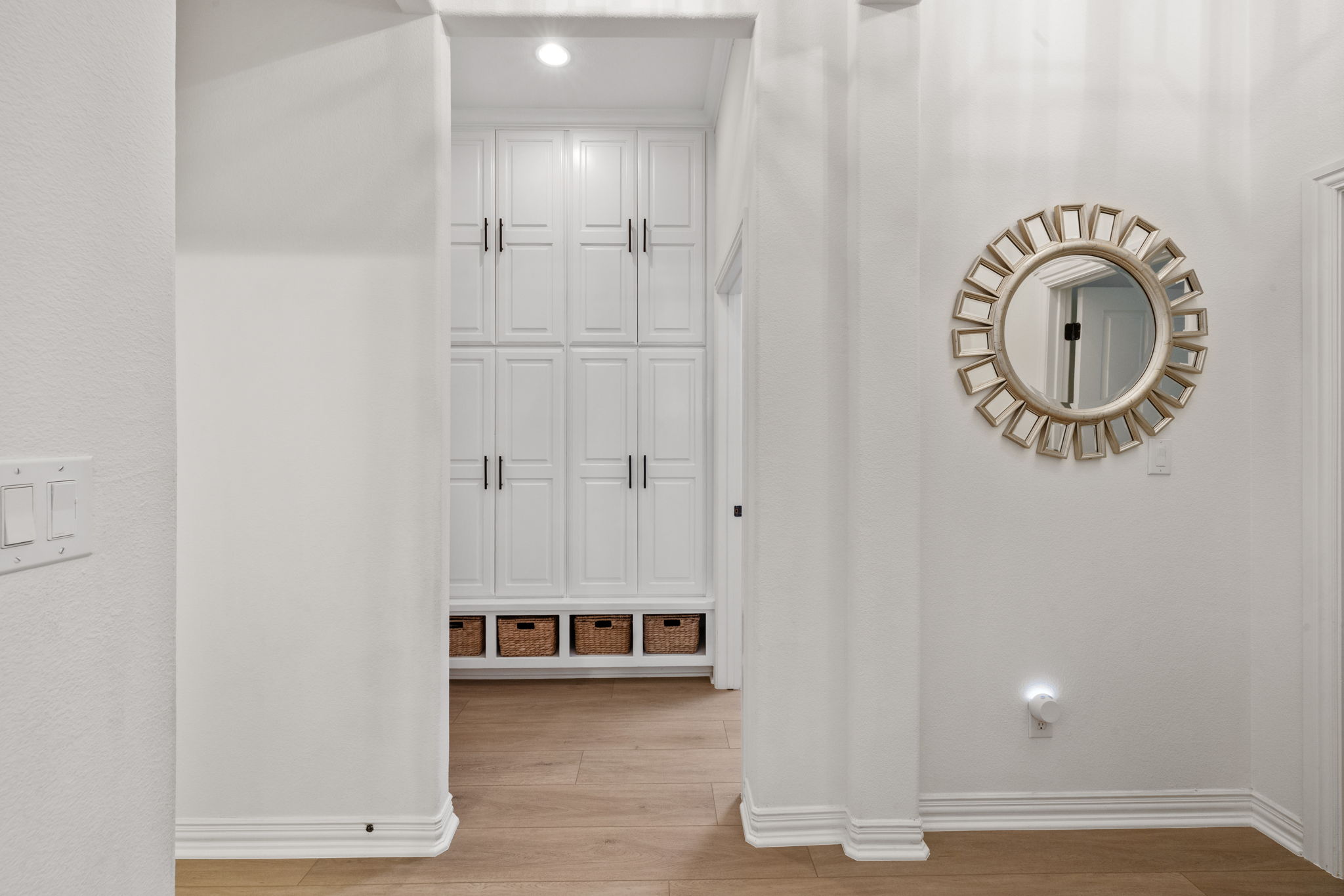 1124 Castle Path Round Rock, TX 78681 - Photo 10 of 40 A streamlined hallway offers clever built-in cabinetry and warm wood flooring.
