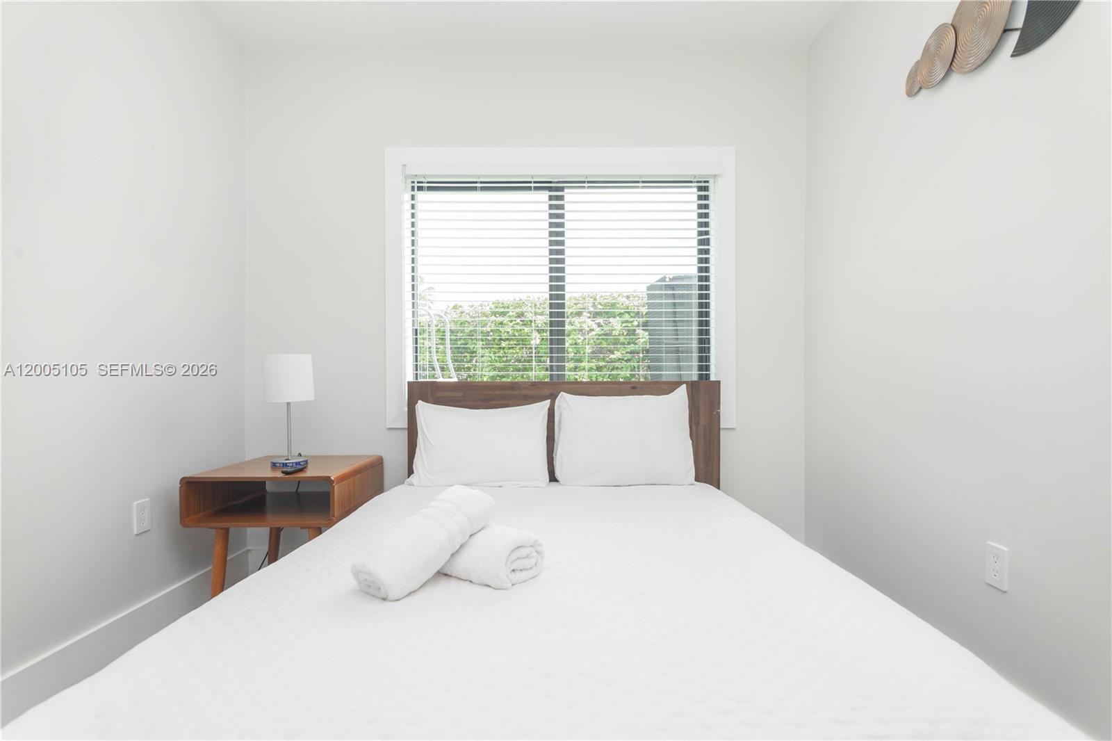 2360 Southwest 12th Street Miami, FL 33135 - Photo 22 of 54 a bedroom with a large bed and a lamp next to a window