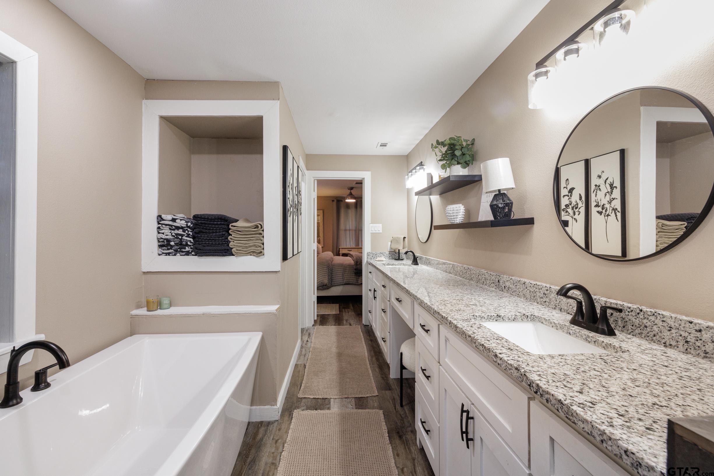 765 County Road 3410 Emory, TX 75440 - Photo 16 of 38 a bathroom with a granite countertop sink and a mirror