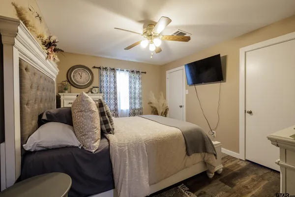 a bed room with a bed mirror and a window