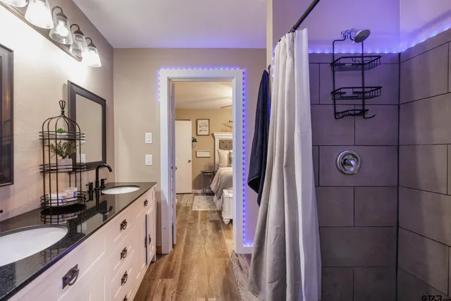 a spacious bathroom with a double vanity sink and a mirror