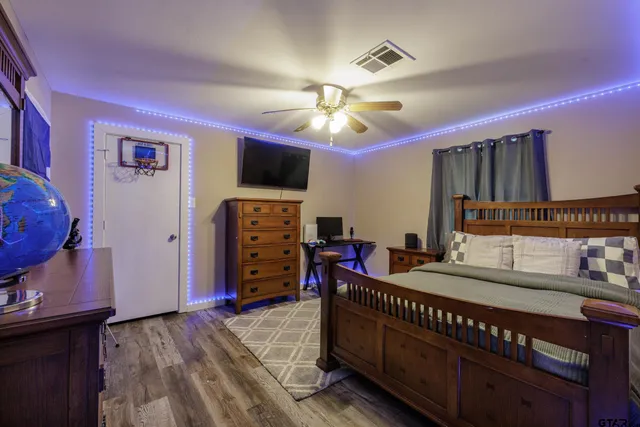 a bedroom with furniture and a flat screen tv